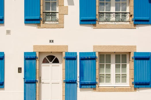 Beautiful facade featuring vibrant blue shutters and white windows for a classic look.