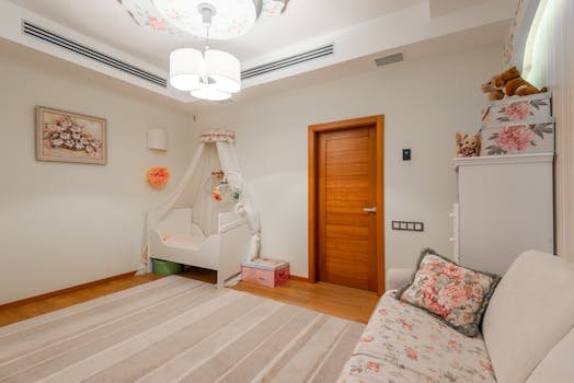 A serene baby nursery featuring a crib, floral accents, and a wooden door for a warm interior.