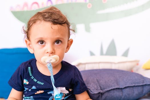 Succes în Educația Timpurie: Studii de Caz Inspiratoare despre Dezvoltarea Copiilor (0-6 Ani) 4 Cute baby with pacifier sitting in colorful playroom. Perfect for parenting and lifestyle concepts.