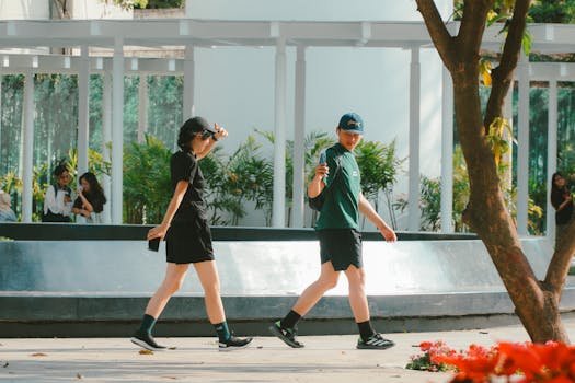 People walking and enjoying a sunny day in a Ho Chi Minh City park, Vietnam.