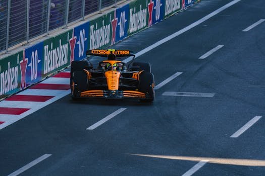 A Formula 1 racing car speeding along the Baku City Circuit during a race event.