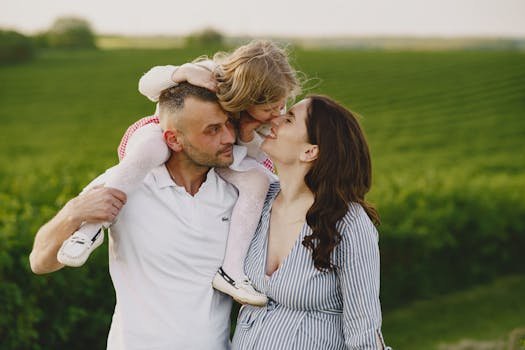 A delightful family moment captured in a lush scenic field, portraying love and happiness.