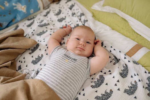 A cute baby lies comfortably on a bed in a charming onesie, exuding warmth and innocence.