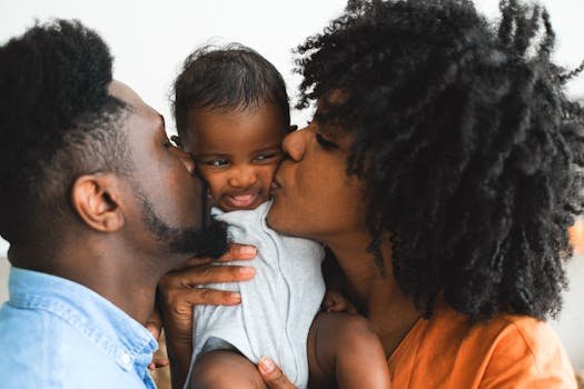 A joyful African American family shares an affectionate moment with their baby.
