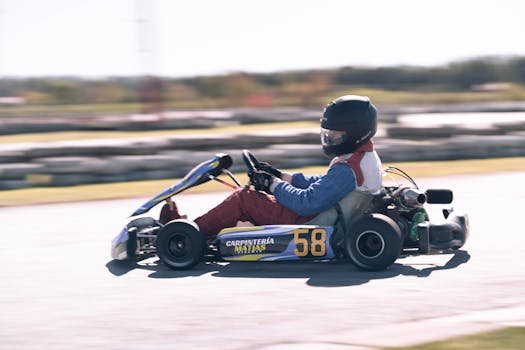 Dynamic image of a go-kart racer in motion, highlighting speed and sport.